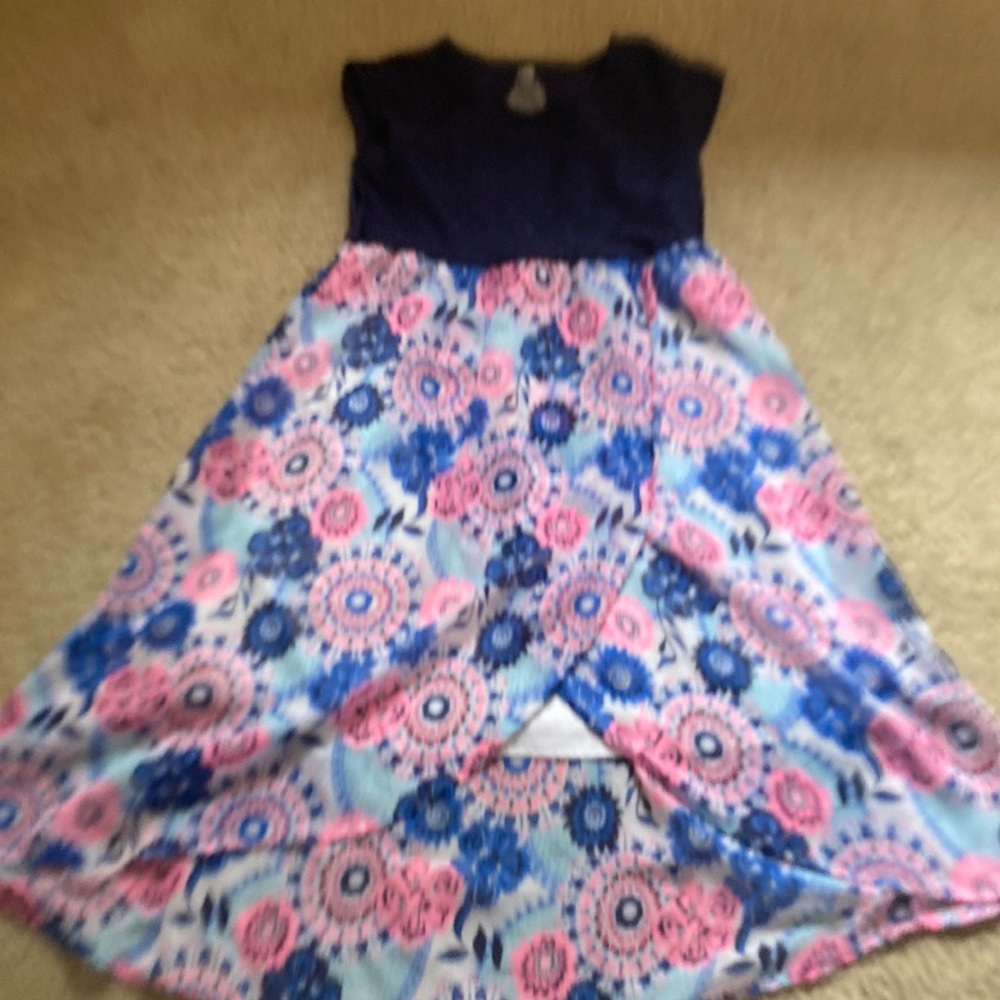 This is a navy blue dress, and on the bottom  there’s pink and blue flowers